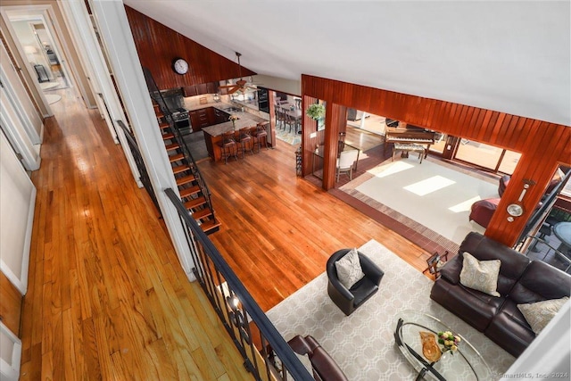 living room with hardwood / wood-style floors and wood walls