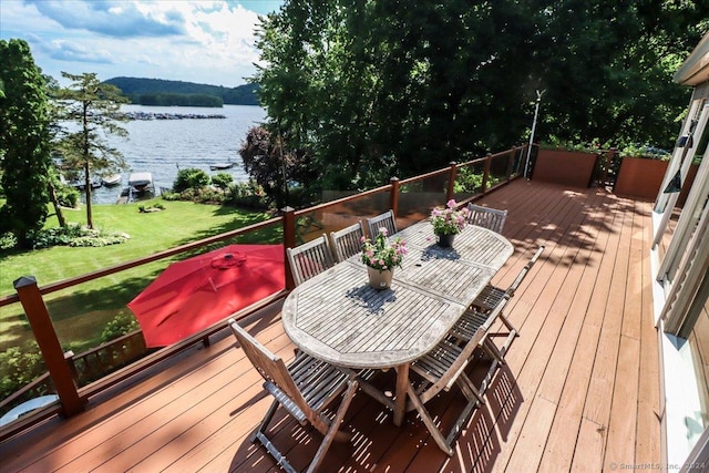 wooden terrace featuring a water view