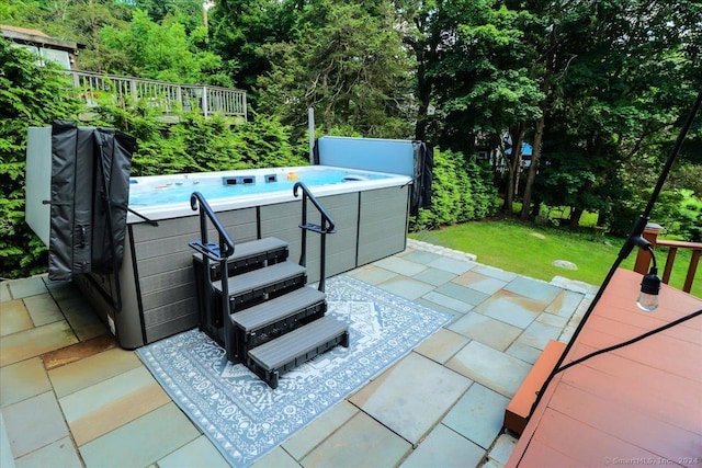 view of patio / terrace with a hot tub