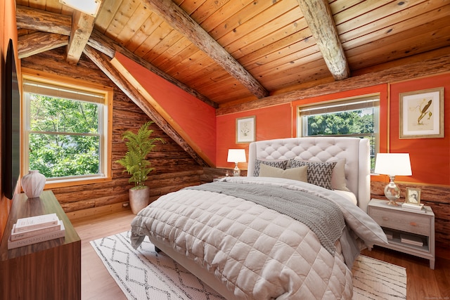 bedroom with wooden ceiling, multiple windows, hardwood / wood-style floors, and rustic walls