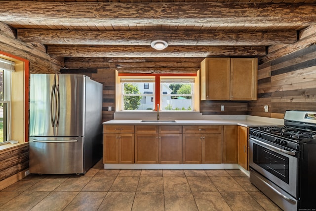 kitchen featuring beamed ceiling, sink, light tile patterned floors, and stainless steel appliances