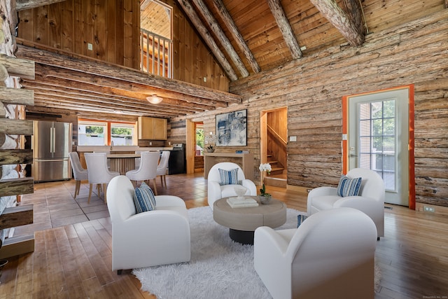 living room featuring log walls, light hardwood / wood-style flooring, sink, high vaulted ceiling, and wooden ceiling