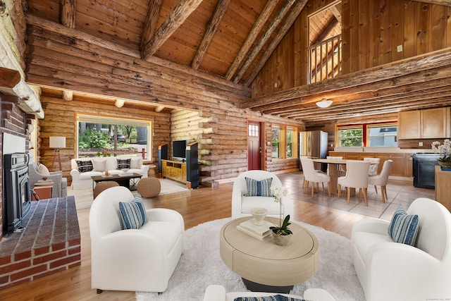 living room featuring plenty of natural light, log walls, a brick fireplace, and high vaulted ceiling