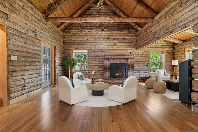 unfurnished living room with a healthy amount of sunlight, hardwood / wood-style flooring, and rustic walls