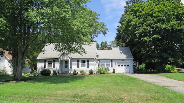 view of front of property with a garage and a front yard