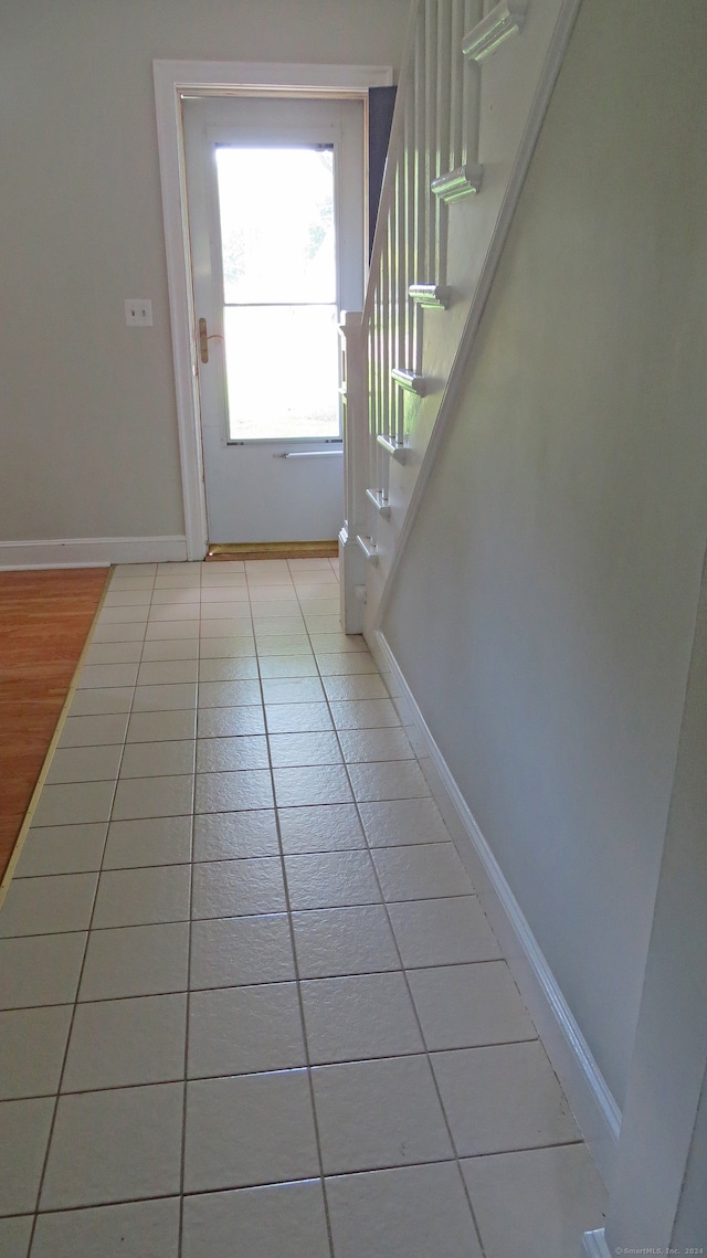 doorway to outside with light tile patterned floors