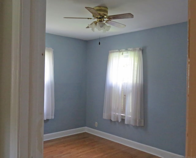 spare room featuring wood-type flooring and ceiling fan