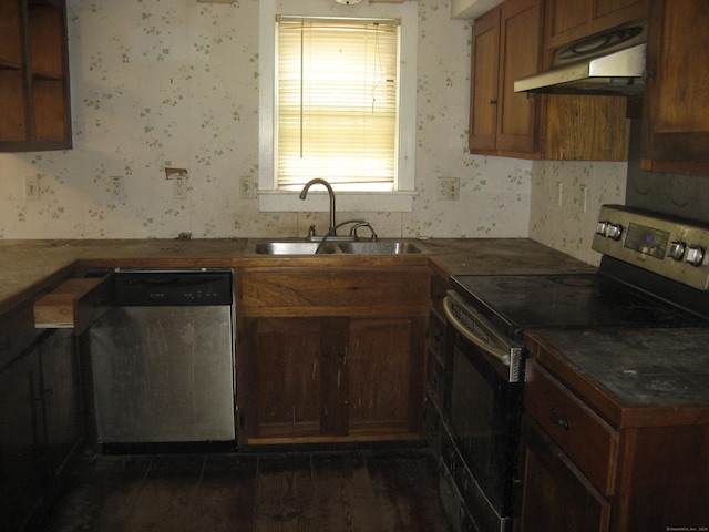 kitchen with appliances with stainless steel finishes, dark hardwood / wood-style flooring, and sink