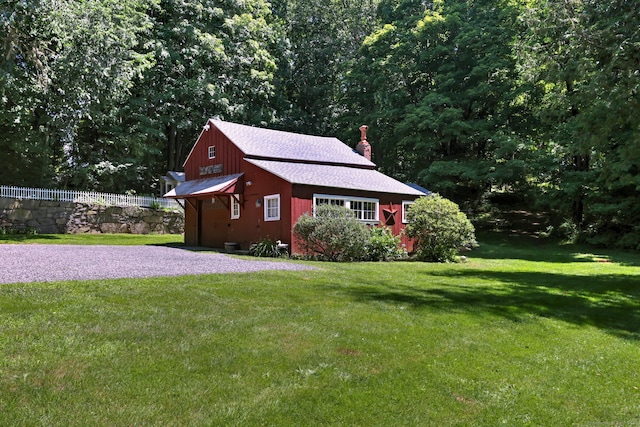 view of outbuilding featuring a lawn