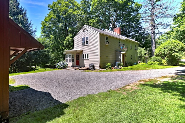 view of side of property featuring a yard