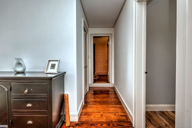 hallway with dark hardwood / wood-style flooring