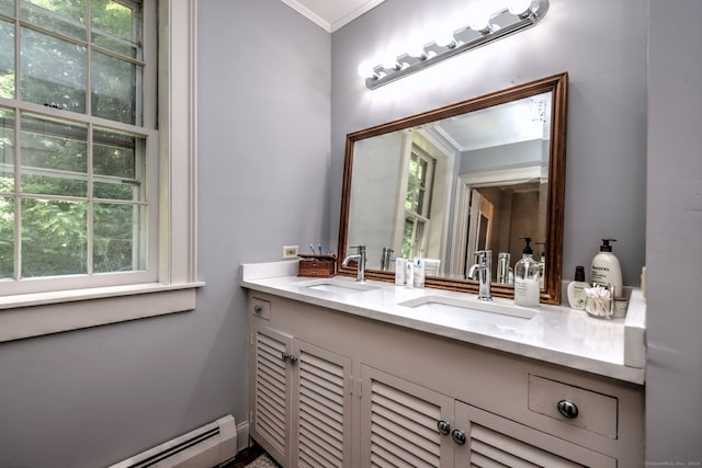 bathroom featuring a baseboard heating unit, a wealth of natural light, and vanity