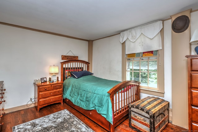 bedroom featuring hardwood / wood-style flooring and crown molding