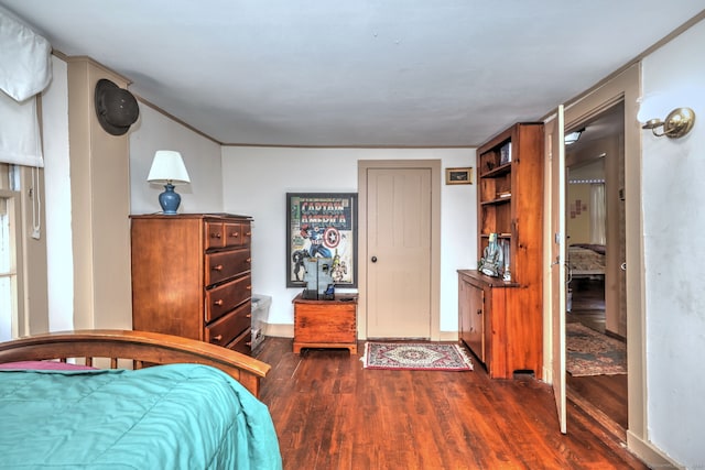 unfurnished bedroom with dark wood-type flooring