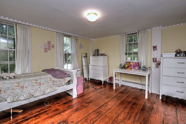 bedroom featuring baseboard heating and hardwood / wood-style floors