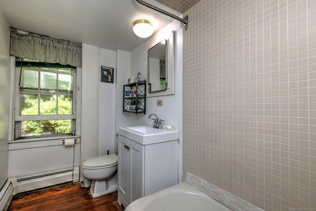 full bathroom featuring vanity, wood-type flooring, tiled shower / bath combo, toilet, and baseboard heating