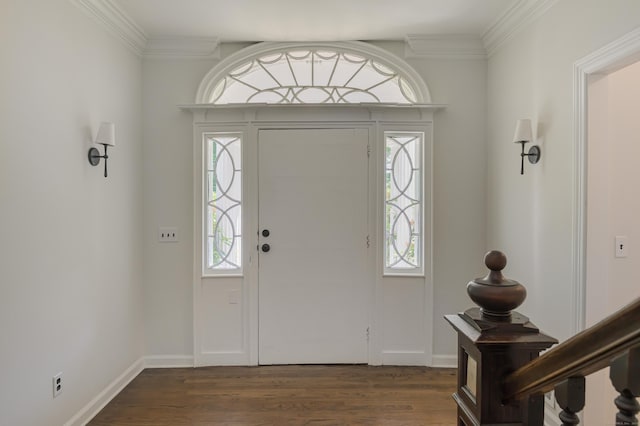 entryway with dark wood-type flooring, ornamental molding, and a healthy amount of sunlight