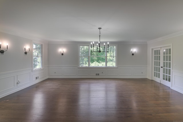 unfurnished dining area with a notable chandelier, dark hardwood / wood-style flooring, french doors, and crown molding