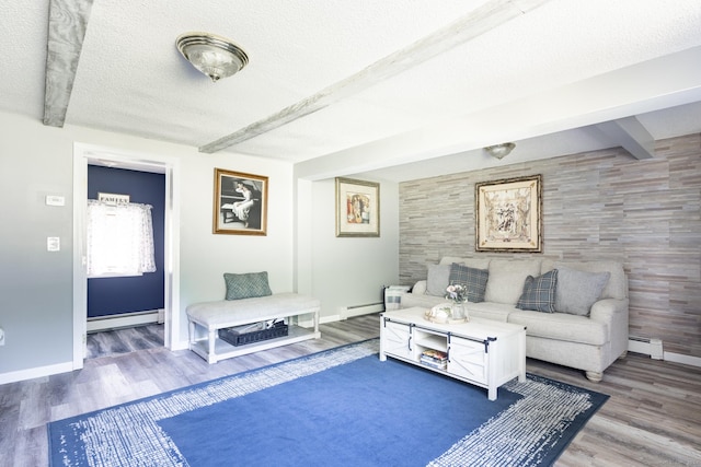 living room with baseboards, a baseboard radiator, an accent wall, a textured ceiling, and beam ceiling