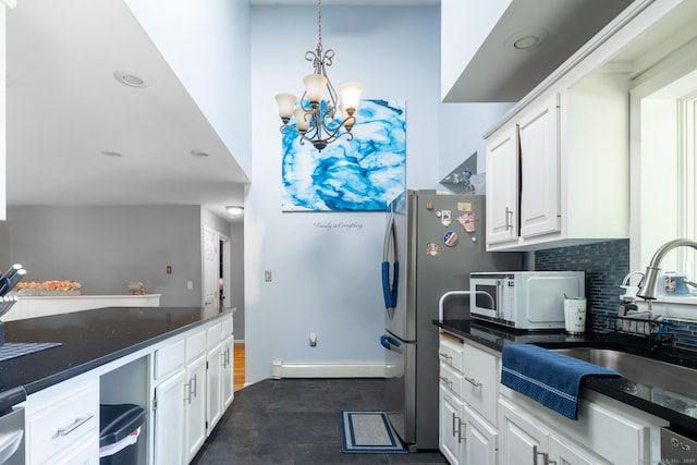 kitchen with white cabinets, a sink, and white microwave