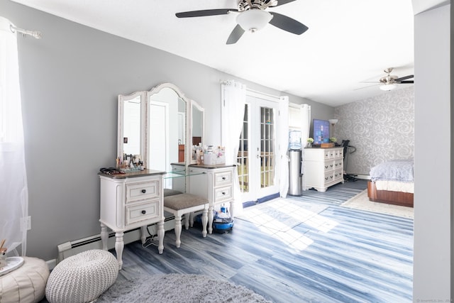 bedroom with wallpapered walls, wood finished floors, access to exterior, french doors, and multiple windows