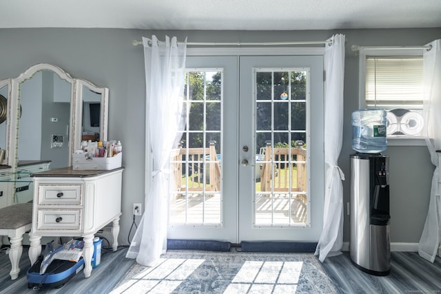 entryway featuring french doors, baseboards, and wood finished floors