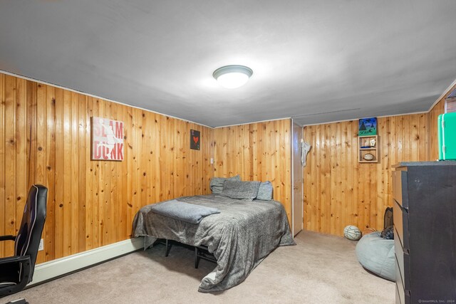 carpeted bedroom featuring wooden walls