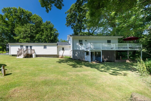 back of house featuring a deck and a lawn