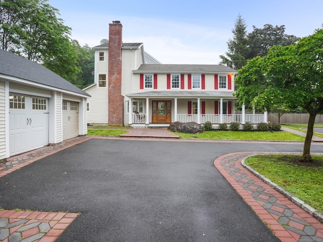 254 W Ave, Darien, CT 06820 - colonial-style house featuring covered porch, a chimney, a garage, and an outbuilding