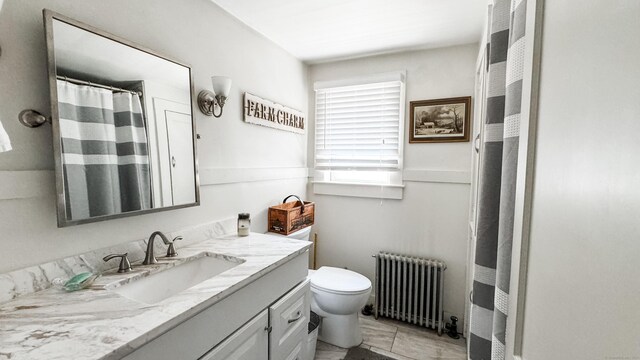 bathroom featuring vanity, radiator heating unit, tile patterned flooring, and toilet