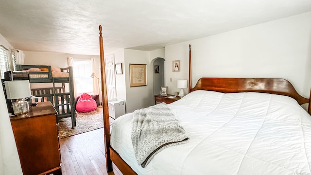 bedroom with hardwood / wood-style flooring