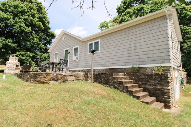 view of property exterior featuring a yard and a patio area