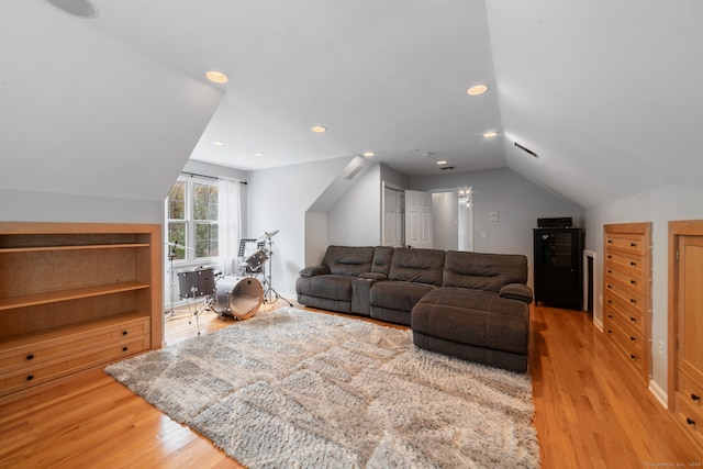 living room with hardwood / wood-style flooring and vaulted ceiling