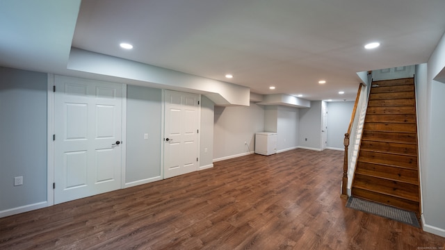 basement with dark hardwood / wood-style floors