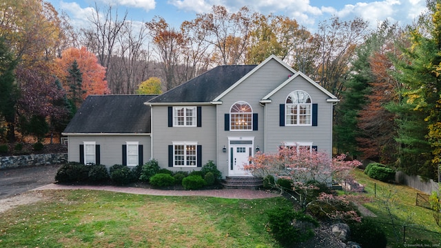 colonial inspired home with a front yard