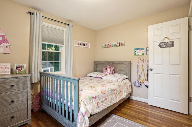 bedroom featuring dark wood-style floors and baseboards