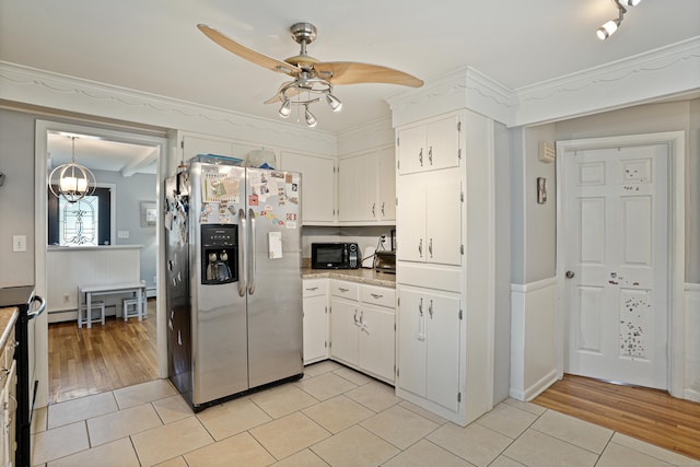 kitchen with black microwave, ceiling fan, light tile patterned floors, light countertops, and stainless steel refrigerator with ice dispenser