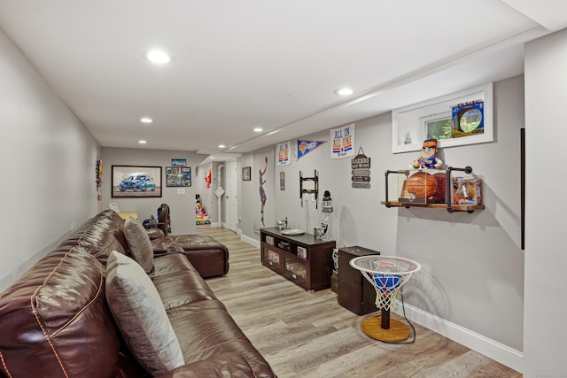 living room with baseboards, wood finished floors, and recessed lighting