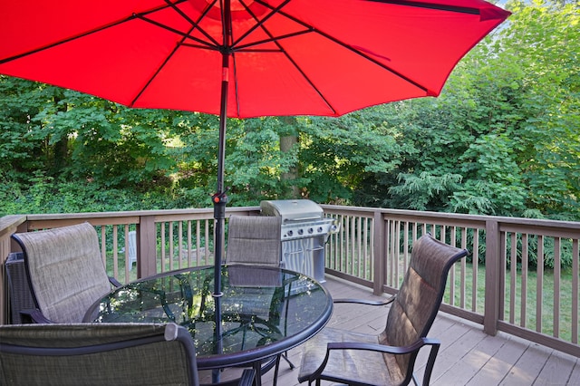 deck with outdoor dining space and a grill