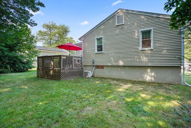 back of house featuring a wooden deck, central AC, and a yard