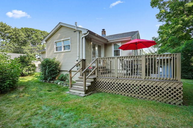 back of property with a yard, french doors, a chimney, and a wooden deck