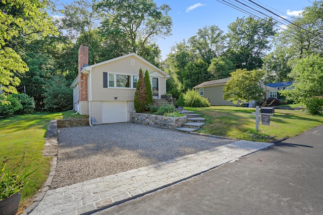 view of front facade with a garage, driveway, a chimney, and a front lawn