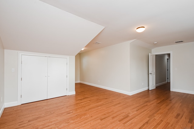 additional living space featuring light hardwood / wood-style flooring