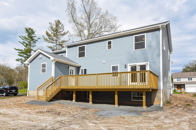 rear view of property featuring a wooden deck