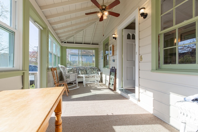 unfurnished sunroom with vaulted ceiling with beams and ceiling fan