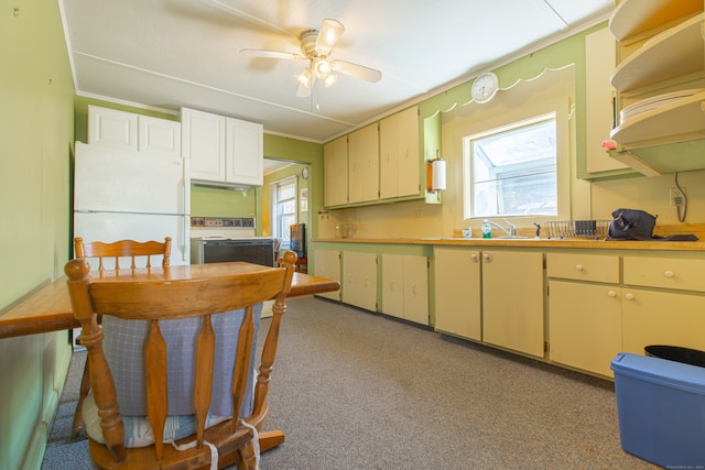 kitchen with plenty of natural light, carpet floors, ceiling fan, and white refrigerator