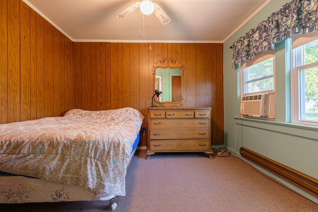 bedroom featuring carpet flooring, ornamental molding, wooden walls, and ceiling fan