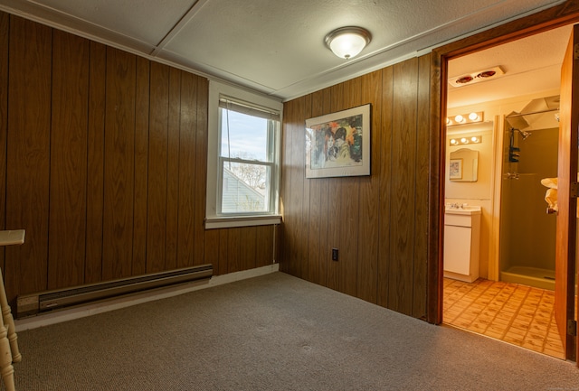 interior space featuring a baseboard heating unit and wooden walls