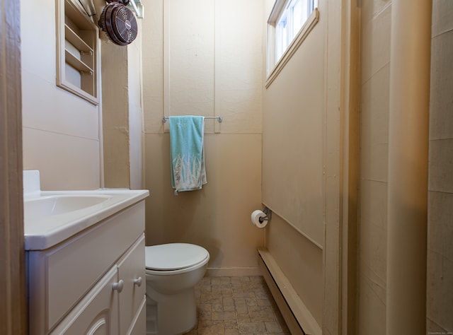 bathroom with vanity, tile patterned floors, a baseboard heating unit, and toilet