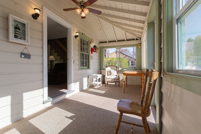 sunroom / solarium with lofted ceiling with beams and ceiling fan